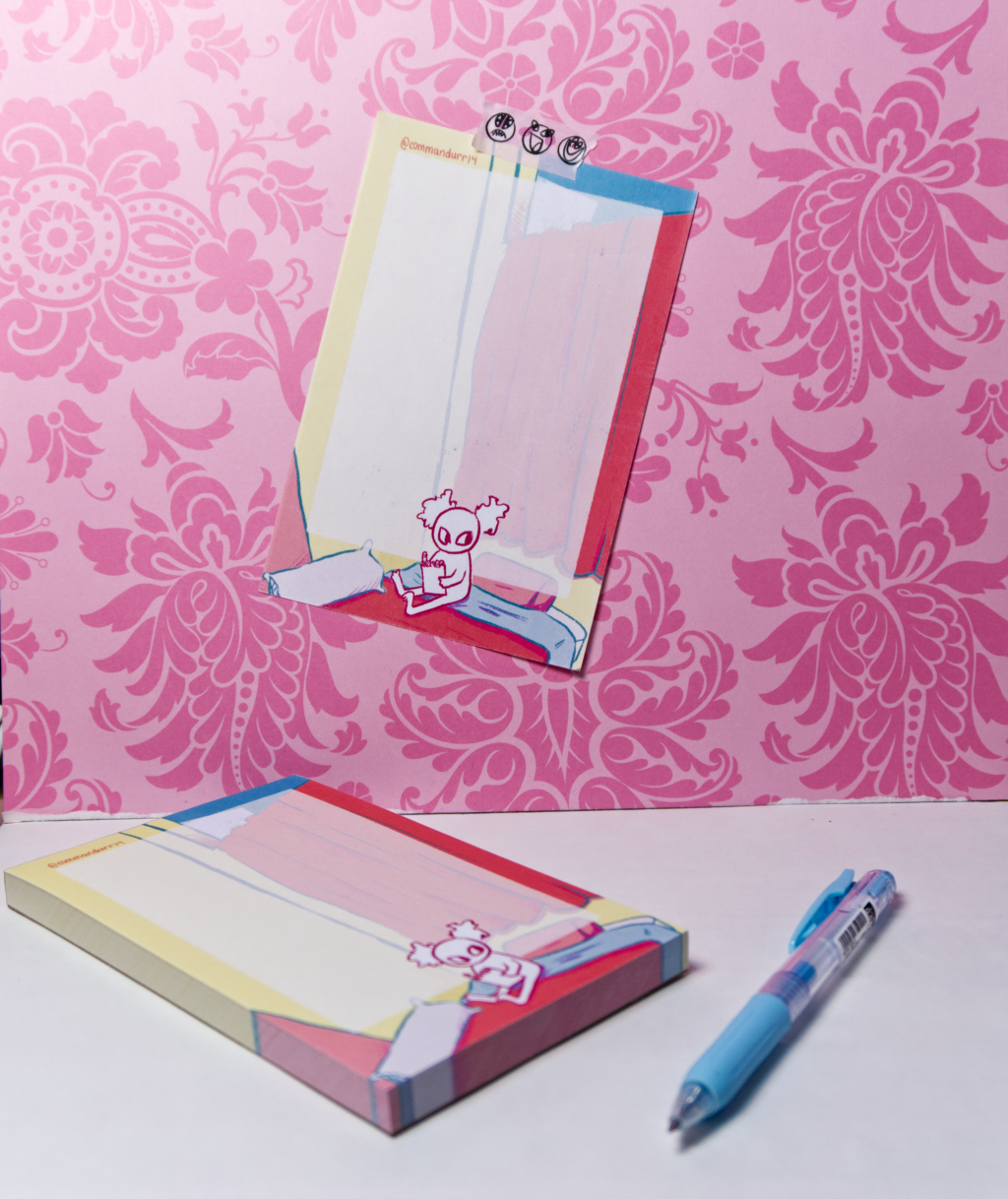A notepad with a page attached to a pink wall, along with a blue pen next to it