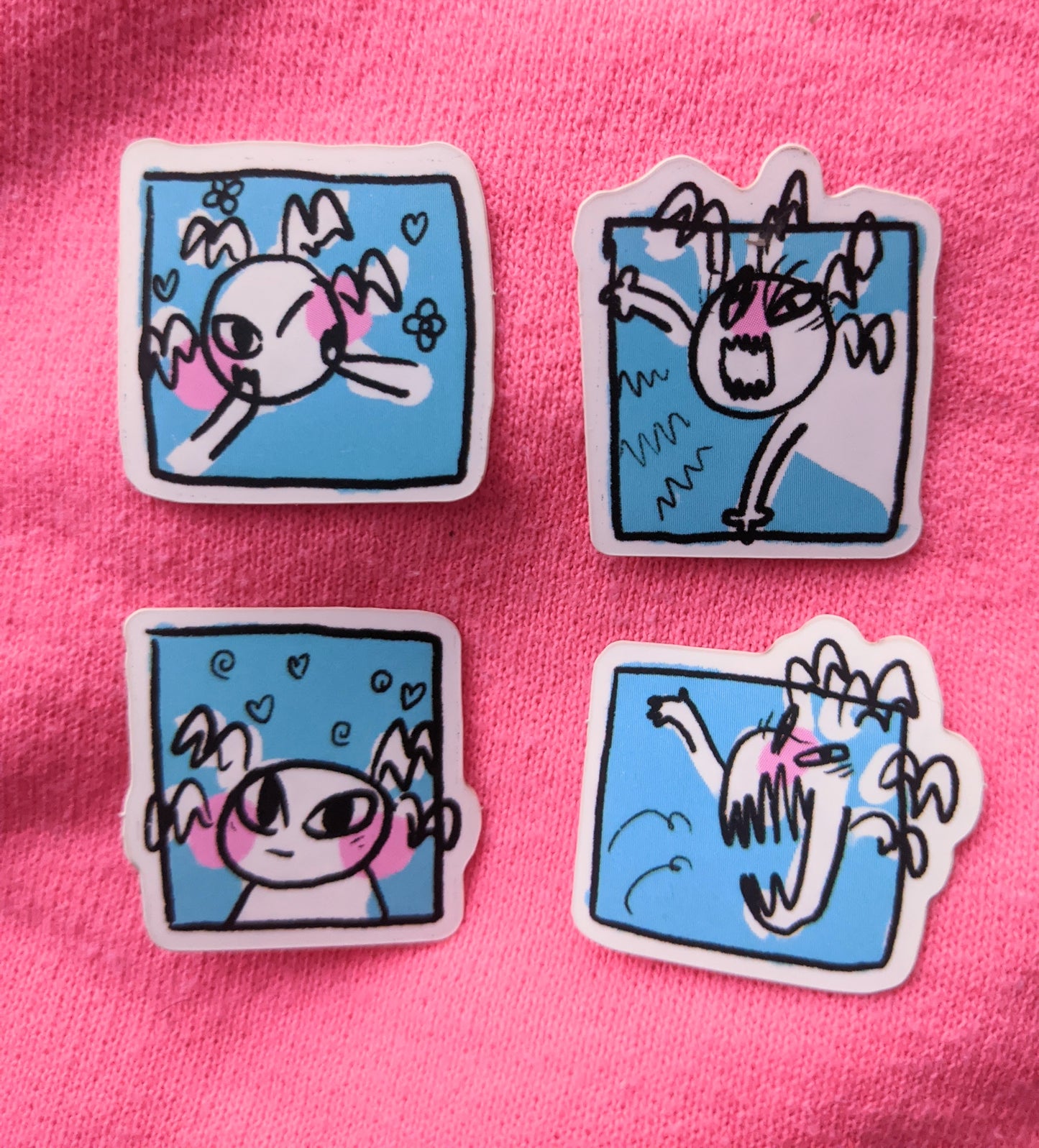 Image of all four cute yet spookie stickers in front of a pink background.